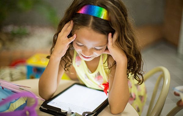 Tween girl on a tablet