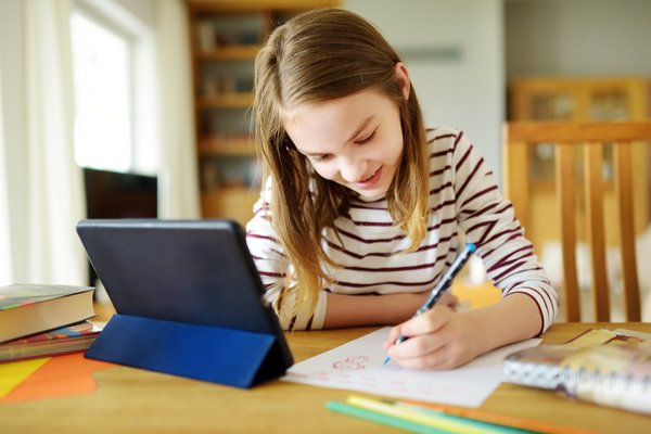 Girl writing on a paper.