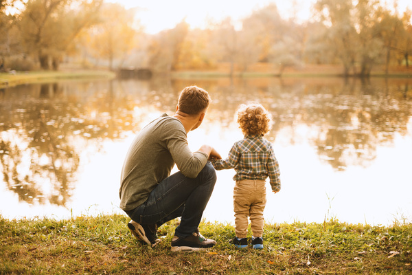 Parent and child looking at a pond.