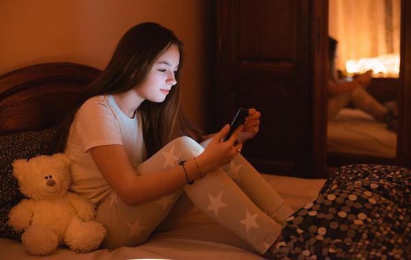 Teenage girl looking at her mobile phone.