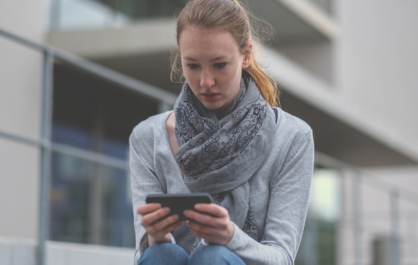 Teenage girl looking at her mobile phone.