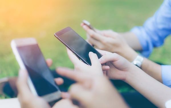Group of people using smartphones.