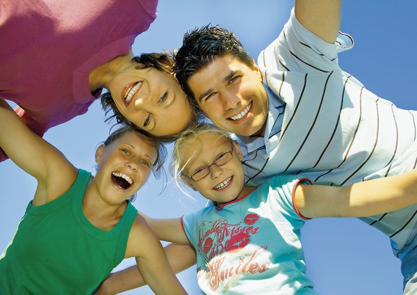 Smiling family forming a circle.