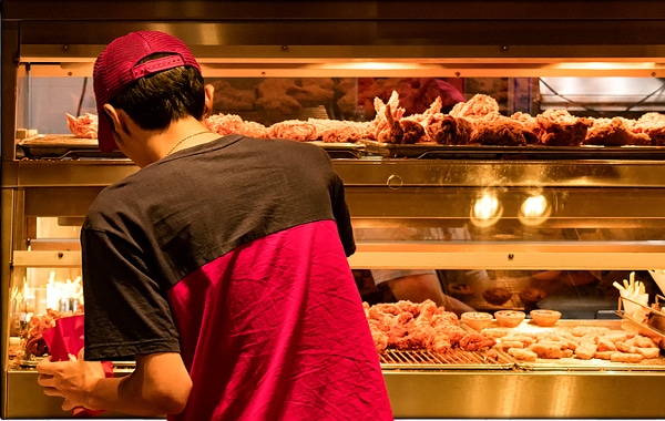 Young man working at a fast food restaurant.