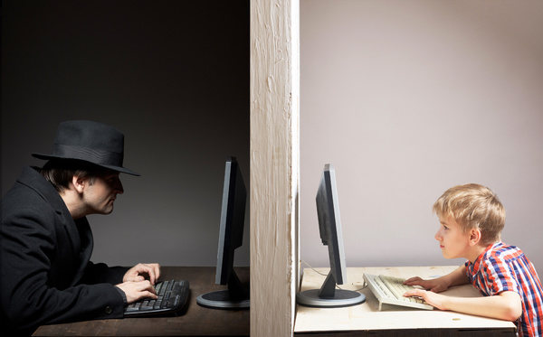 Teen looking at his computer screen.